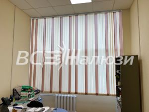 Полосатые бело-розовые вертикальные жалюзи над рабочим столом